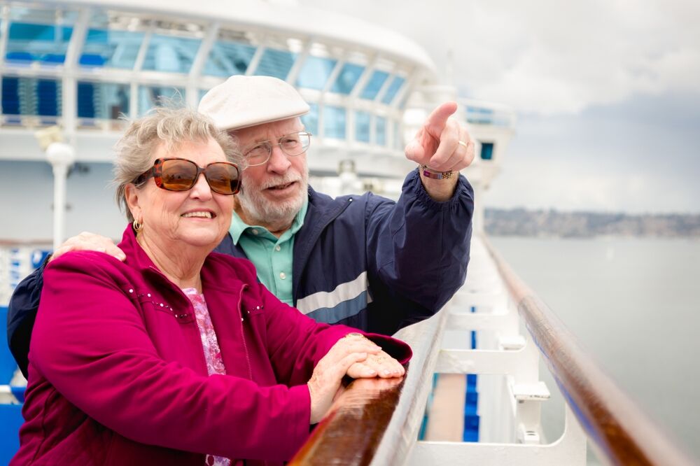 An elderly couple enjoys a boat trip