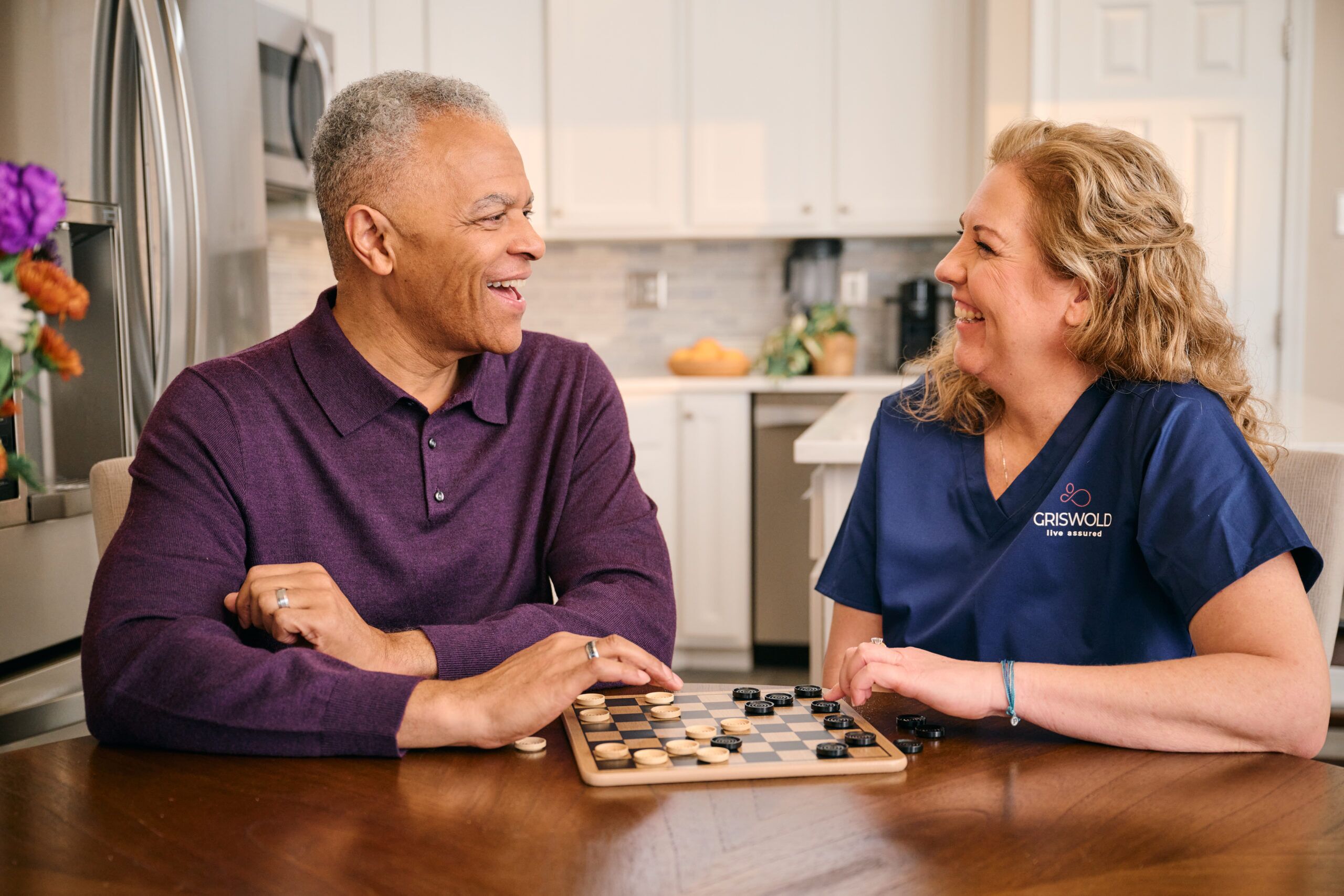 Caregiver playing a board game with client