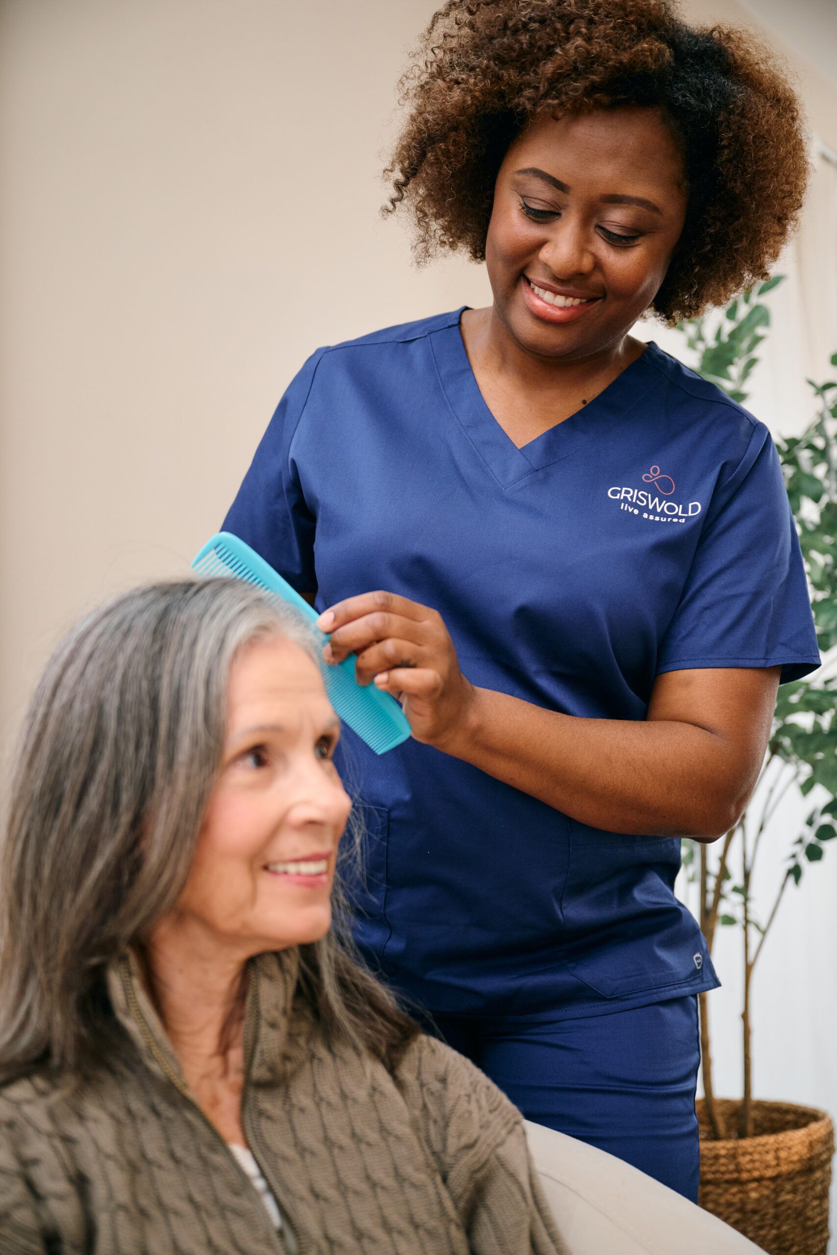 Caregiver combing a client's hair